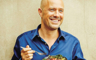 Dale Pinnock eating one of his recipes with a plain background