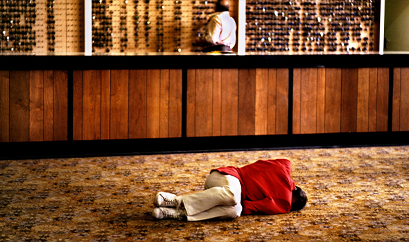 Iemand ligt op de vloer in de lobby van een hotel