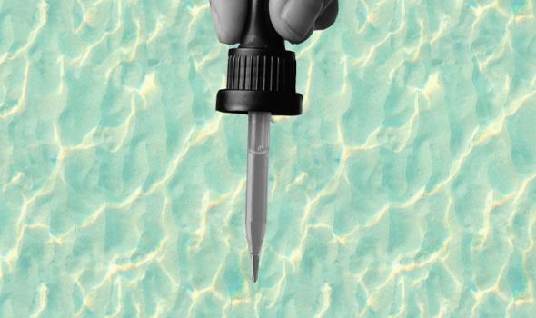 A pipette being held over water